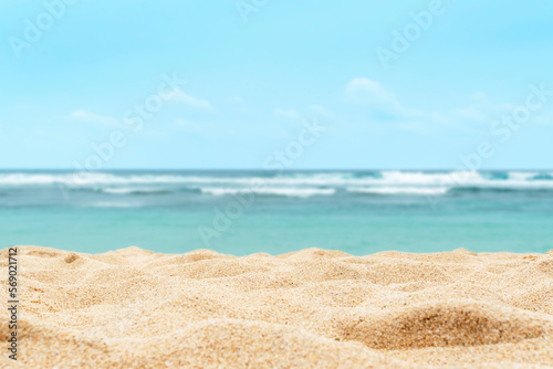 Fototapeta Naklejka Na Ścianę i Meble -  Empty sandy beach in the background with a blurry summer sea.
