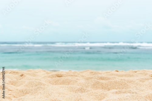 Empty sandy beach in the background with a blurry summer sea. © Владимир Солдатов