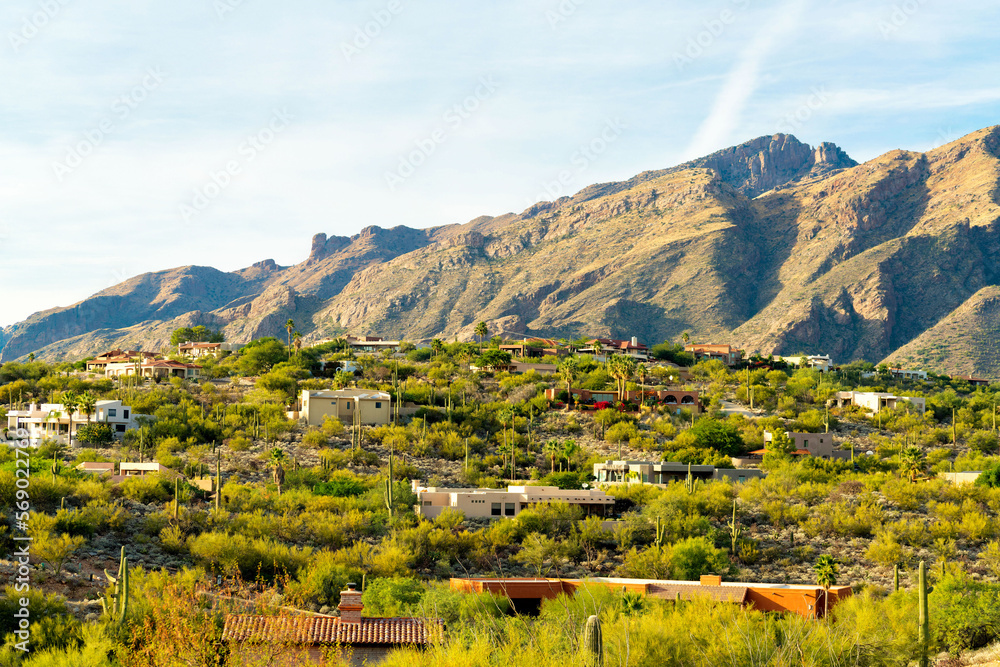 Ridge rilled with houses or homes in a mansion community in the hills of the sonora desert in arizona with visible moutains