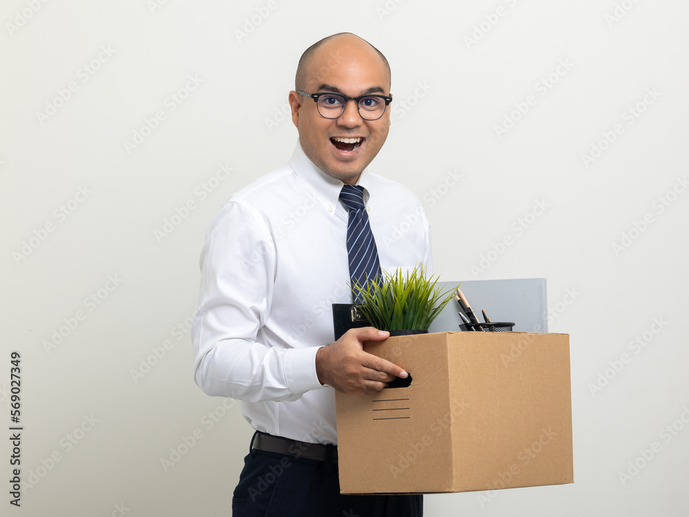 Employee first day working in the office. Happy Businessman with box cardboard personal item getting new jobs. Young man start working new office standing on isolated white background. Employee first day working in the office. Happy Businessman with box cardboard personal item getting new jobs. Young man start working new office standing on isolated white background.
