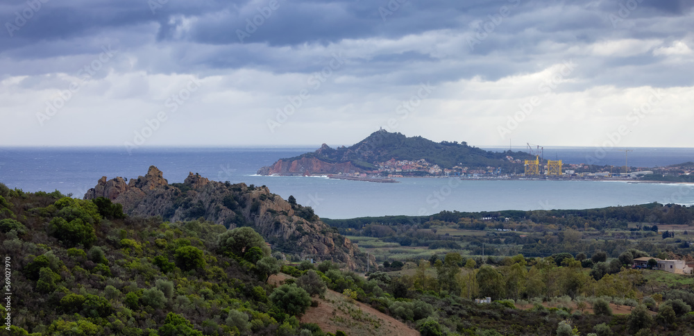 Rocky Mountain Landscape by the Sea and Touristic Town, Santa Maria Navarrese, Sardinia, Italy.