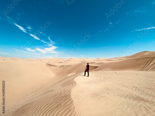 A man standing in the middle of the desert in Peru