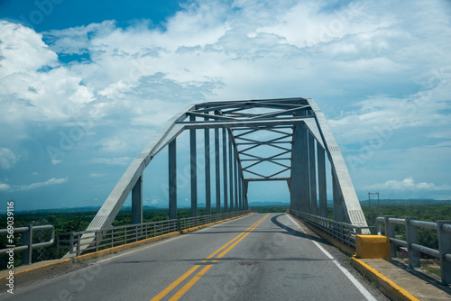 Fototapeta Naklejka Na Ścianę i Meble -  Steel bridge on a rural Colombian highway.