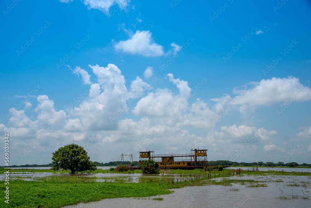 Fototapeta premium Old river ship abandoned on a bank of the Magdalena river. Colombia.