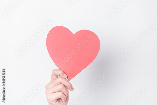 A photo of a red heart shape paper isolated on white background.