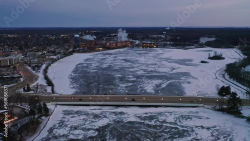 Aerial, Stevens Point during winter, frozen Wisconsin River in the evening