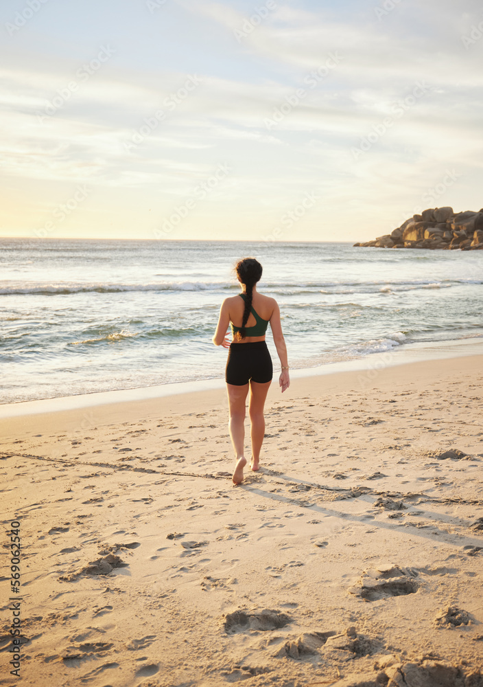 Woman, beach and walking on sand for travel, vacation or holiday in nature for summer. Fitness person at ocean for sea or water view for peace, relax and calm time for freedom and mental health Woman, beach and walking on sand for travel, vacation or holiday in nature for summer. Fitness person at ocean for sea or water view for peace, relax and calm time for freedom and mental health