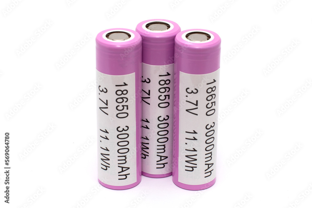 Three pink lithium batteries isolated on a white background with an inscription pasted on them about capacity and voltage , rechargeable batteries for appliances Three pink lithium batteries isolated on a white background with an inscription pasted on them about capacity and voltage , rechargeable batteries for appliances
