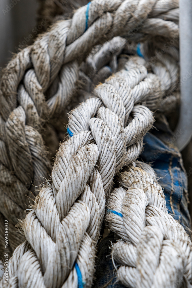 fully frame image of old grey coiled nylon marine or fishing rope. Selective focus.
