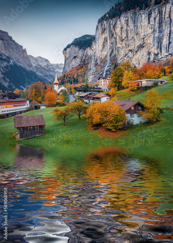 Lauterbrunnen village reflected in the calm waters of small lake. Impressive rural scene of Swiss Alps, Bernese Oberland in the canton of Bern, Switzerland. Beauty of countryside concept background..