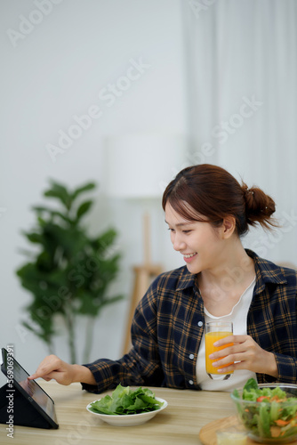 Portrait of happy playful asian girl eating fresh salad  in diet concept