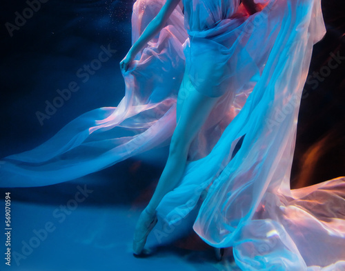 Ballerina's legs underwater, ballet dancer. Under water. Blurred soft focus.