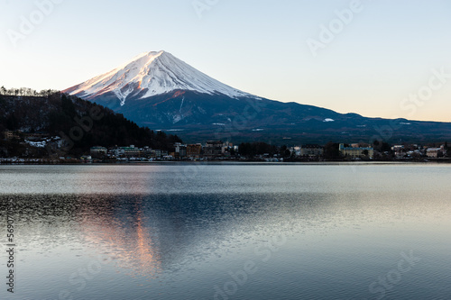 Mount Fuji on a bright winter morning  as seen from across lake Kawaguchi  and the nearby town of Kawaguchiko.