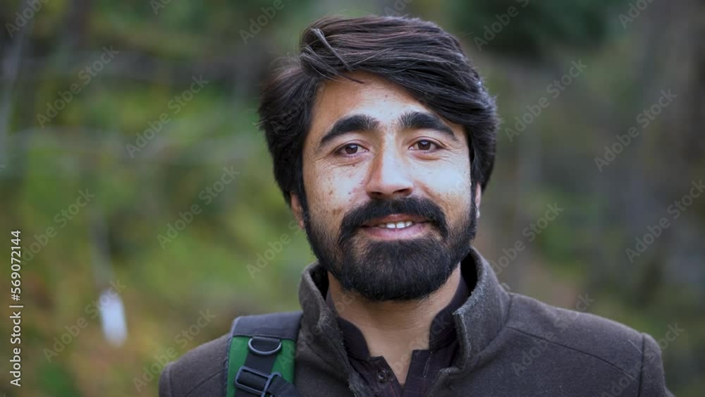 Close-up shot of a young Kashmiri male - A Kashmiri man smiling toward the camera Close-up shot of a young Kashmiri male - A Kashmiri man smiling toward the camera