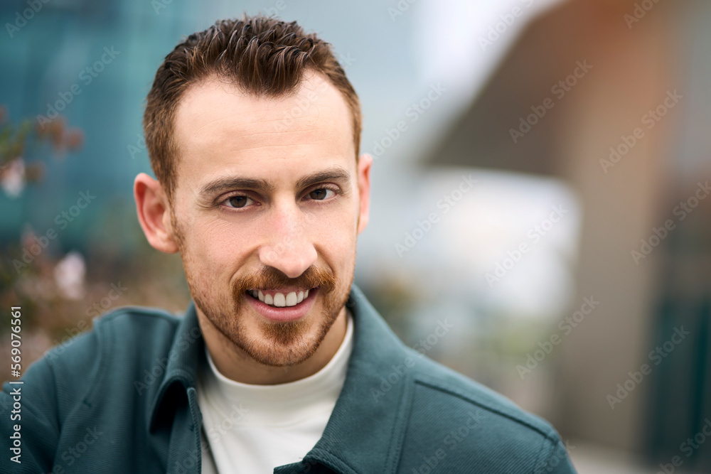 Portrait of smiling confident man posing to camera at business district Portrait of smiling confident man posing to camera at business district
