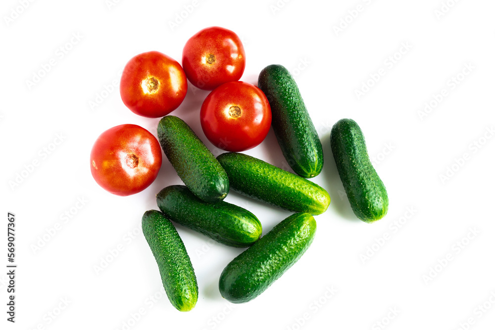 plan view of green fresh cucumbers and red tomatoes isolated on white background plan view of green fresh cucumbers and red tomatoes isolated on white background