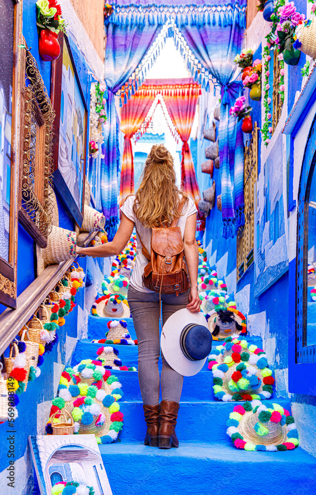 Tourism at Chefchaouen,  woman with backpack explore blue typical moroccan city
