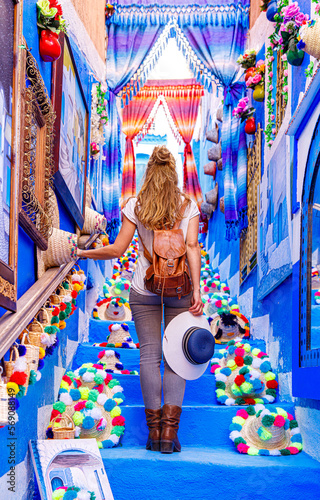 Tourism at Chefchaouen,  woman with backpack explore blue typical moroccan city © M.studio