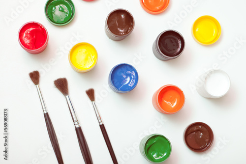 Wallpaper Mural gouache paint jars with brushes on white. hobby painting workplace- creativity home flat lay Torontodigital.ca