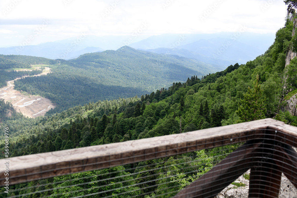 View from the observation tower to the mountains covered with forest. Summer, day. Adygea, Russia