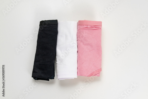 folded set of colorful cotton panties on a white background. the concept of classic underwear made of natural fabrics.