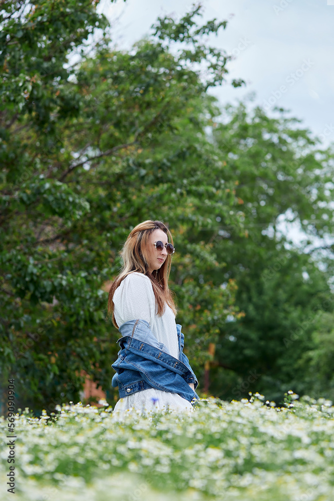 Sensual young woman in chamomile field. Sensual young woman relaxing. Connecting with nature. Summertime Sensual young woman in chamomile field. Sensual young woman relaxing. Connecting with nature. Summertime