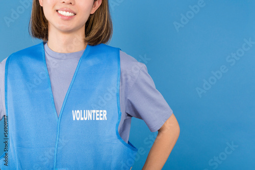 Unrecognizable asian volunteer wearing a blue waistcoat photo