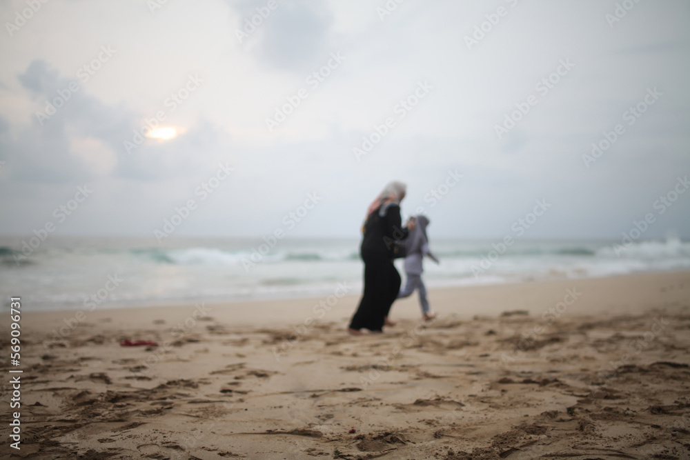 blur of two people running on the beach blur of two people running on the beach