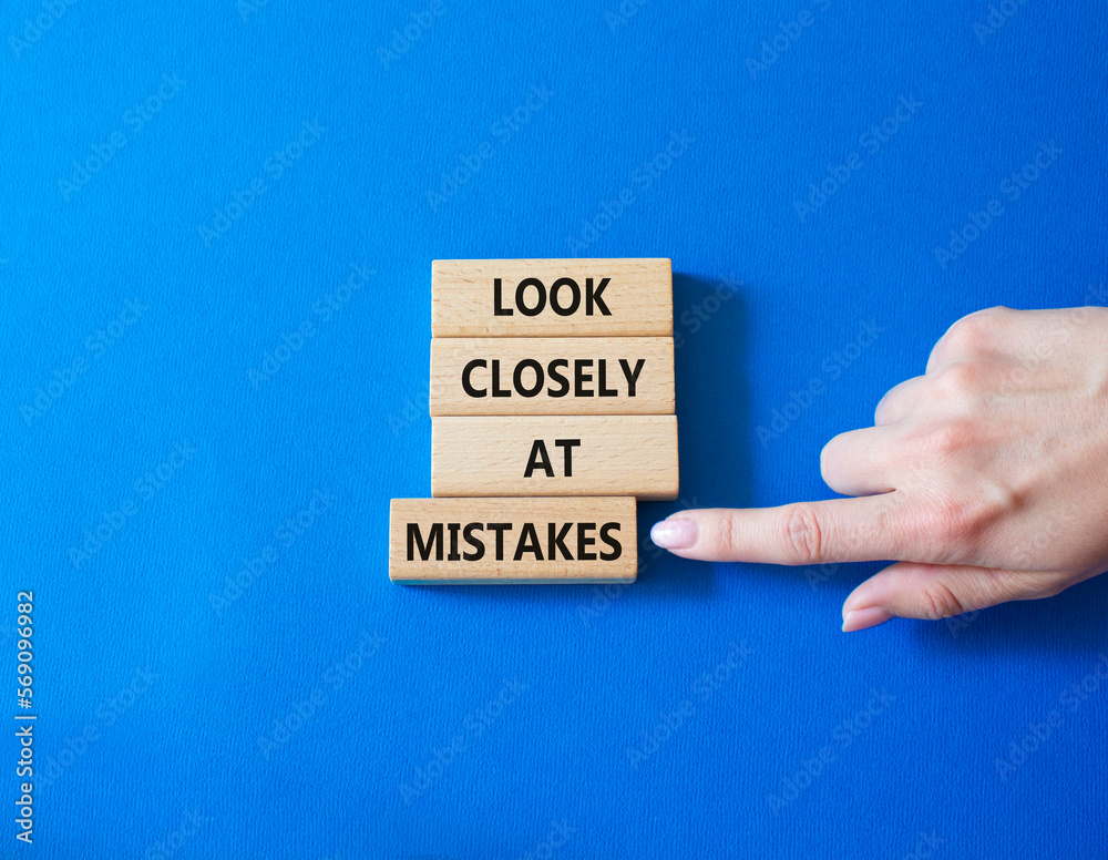 Look closely at mistakes symbol. Wooden blocks with words Look closely at mistakes. Businessman hand. Beautiful blue background. Business and Look closely at mistakes concept. Copy space. Look closely at mistakes symbol. Wooden blocks with words Look closely at mistakes. Businessman hand. Beautiful blue background. Business and Look closely at mistakes concept. Copy space.