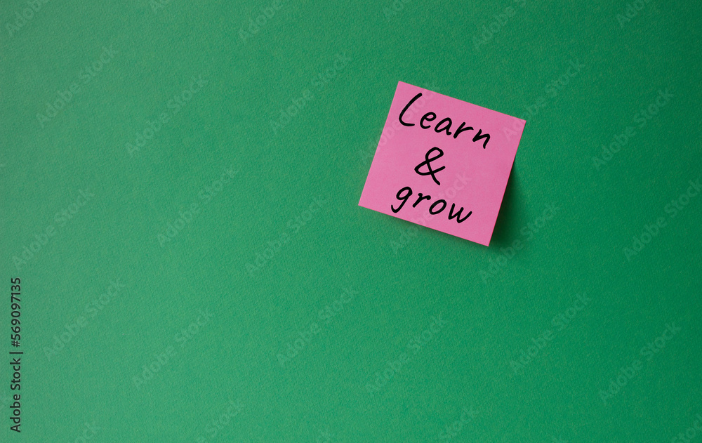 Learn and grow symbol. Concept words Learn and grow on pink steaky note. Beautiful green background. Business and Learn and grow concept. Copy space.
