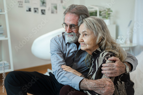 Dreamy middle aged senior loving retired family couple are hugging,Enjoying peaceful moment relaxing together on cozy sofa in living room.