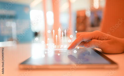 close up businessman hand touch screen on digital tablet to use marketing tool and check traffic research of pay per click program on web page for online business and lifestyle concept