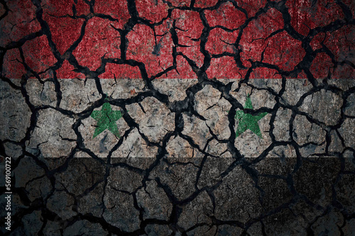 Earthquake in Syria. Flag of Syria on cracked ground. Cracked flag of Syria.