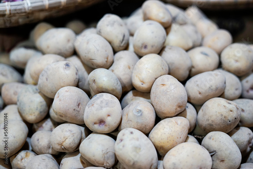 raw potatoes in traditional market photo
