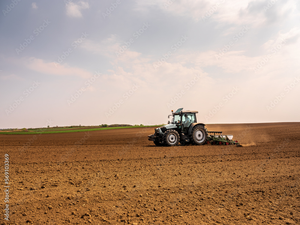 Agricultural worker using a tractor to plant soybean seeds Agricultural worker using a tractor to plant soybean seeds