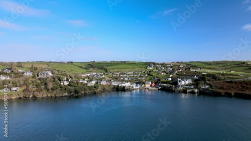 Wide aerial panorama with green hills, dotted houses and old fort - Charles Fort in the background and a part of the Castlepark peninsula in Kinsale, Ireland photo