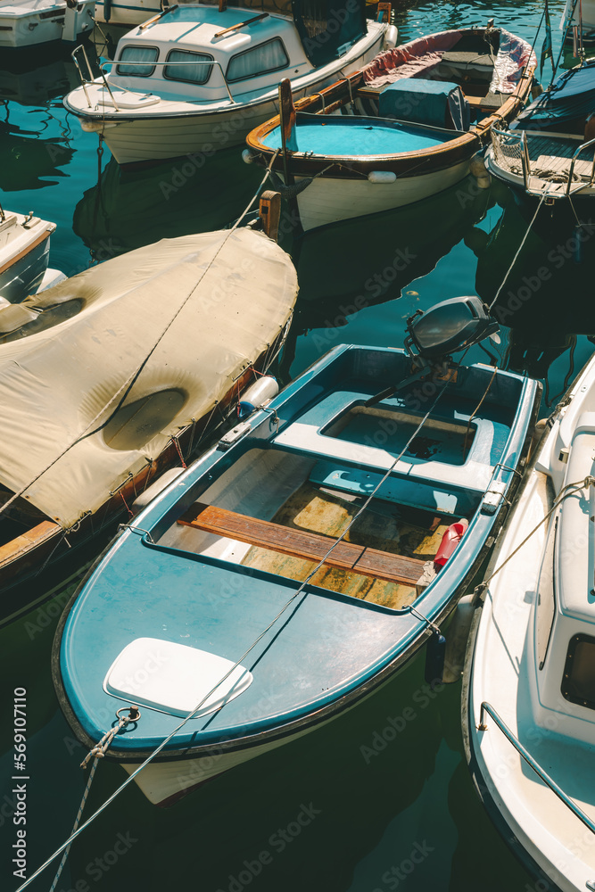 Fishing dinghy boats moored in small marina in town of Lovran, Croatia