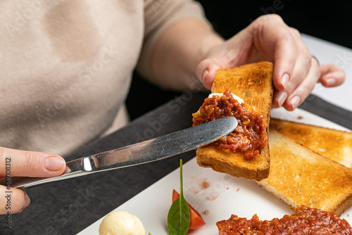 delicious tartar on a white plate with croutons
