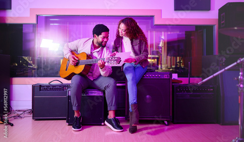 Fotografie Black man, woman and songwriting with guitar, studio and night with paper for creative lyrics, notes and ideas
