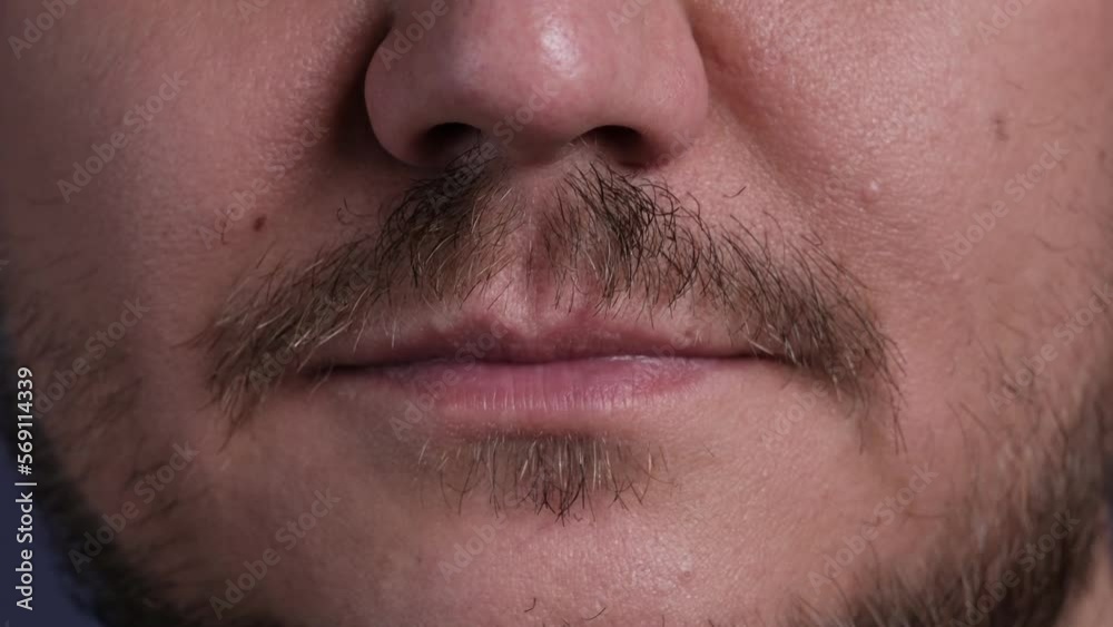 Extreme close up shot of the mouth of a young man. Lips of a smiling guy. Extreme close up shot of the mouth of a young man. Lips of a smiling guy.
