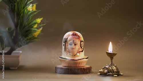 Shiva Shankar God statue with wooden base, Home Decoration, meditation video, shiv murti in table with diya agarbati smoke video   photo