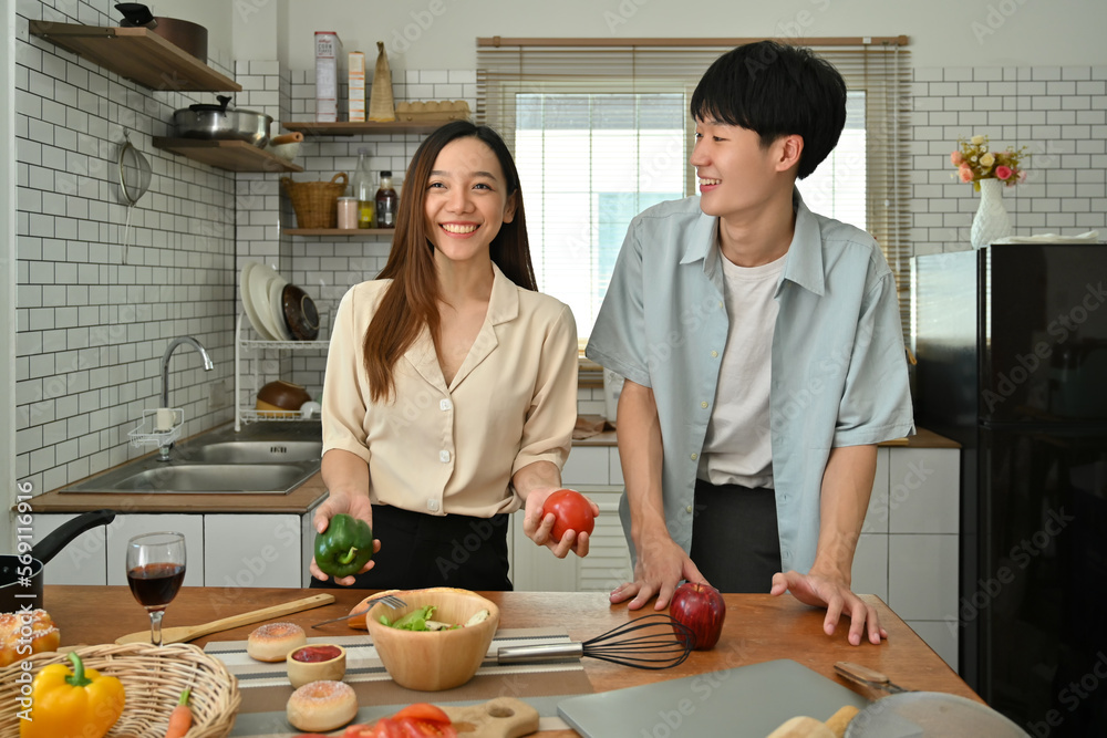 Happy asian couple preparing ingredient for making healthy salad in home kitchen. Love, relationship, people and family Happy asian couple preparing ingredient for making healthy salad in home kitchen. Love, relationship, people and family