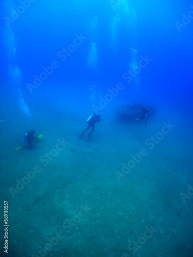 some divers in a small sunken ship in the crystal clear waters of the caribbean sea