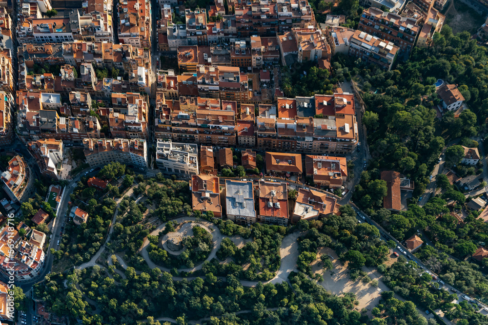 Aerial view of Tibidabo mountain neighborhood with the typical buildings of Barcelona cityscape from helicopter. top view
