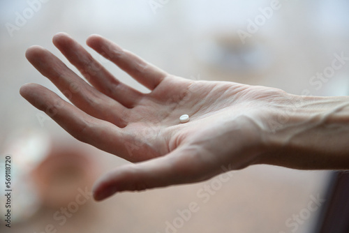 Image of woman with pills in hand