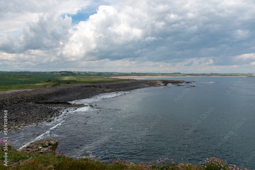 Northumberland coastline, with cloudy skies over the North Sea. At Dunstanburgh Castle between the villages of Craster and Embleton