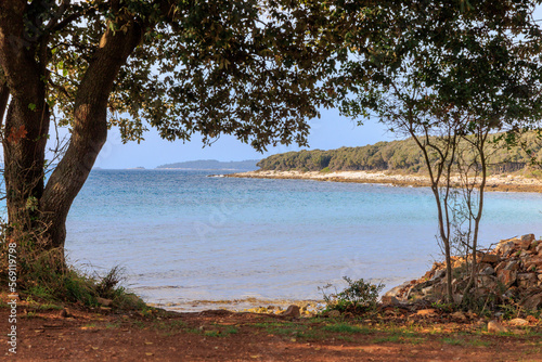 Rocky beach with blue sea at Cisterna Beach near Rovinj