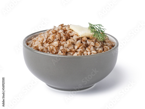 Bowl of tasty buckwheat porridge with butter and dill on white background