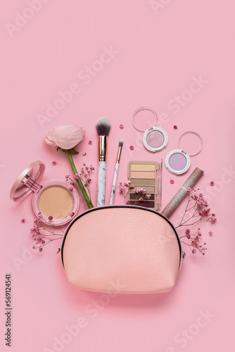 Composition with bag, cosmetics and flowers on pink background