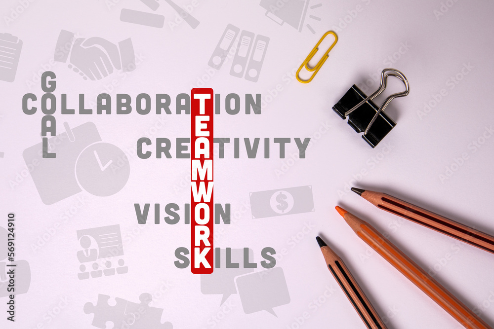 TEAMWORK concept. Illustration with text and icons, crossword puzzle. Stationery on the table TEAMWORK concept. Illustration with text and icons, crossword puzzle. Stationery on the table